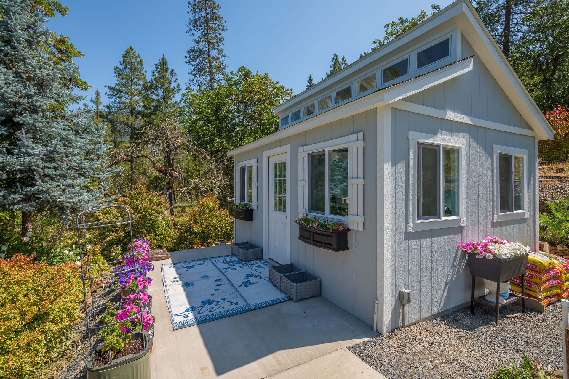 Garden shed with flower boxes and a sitting patio