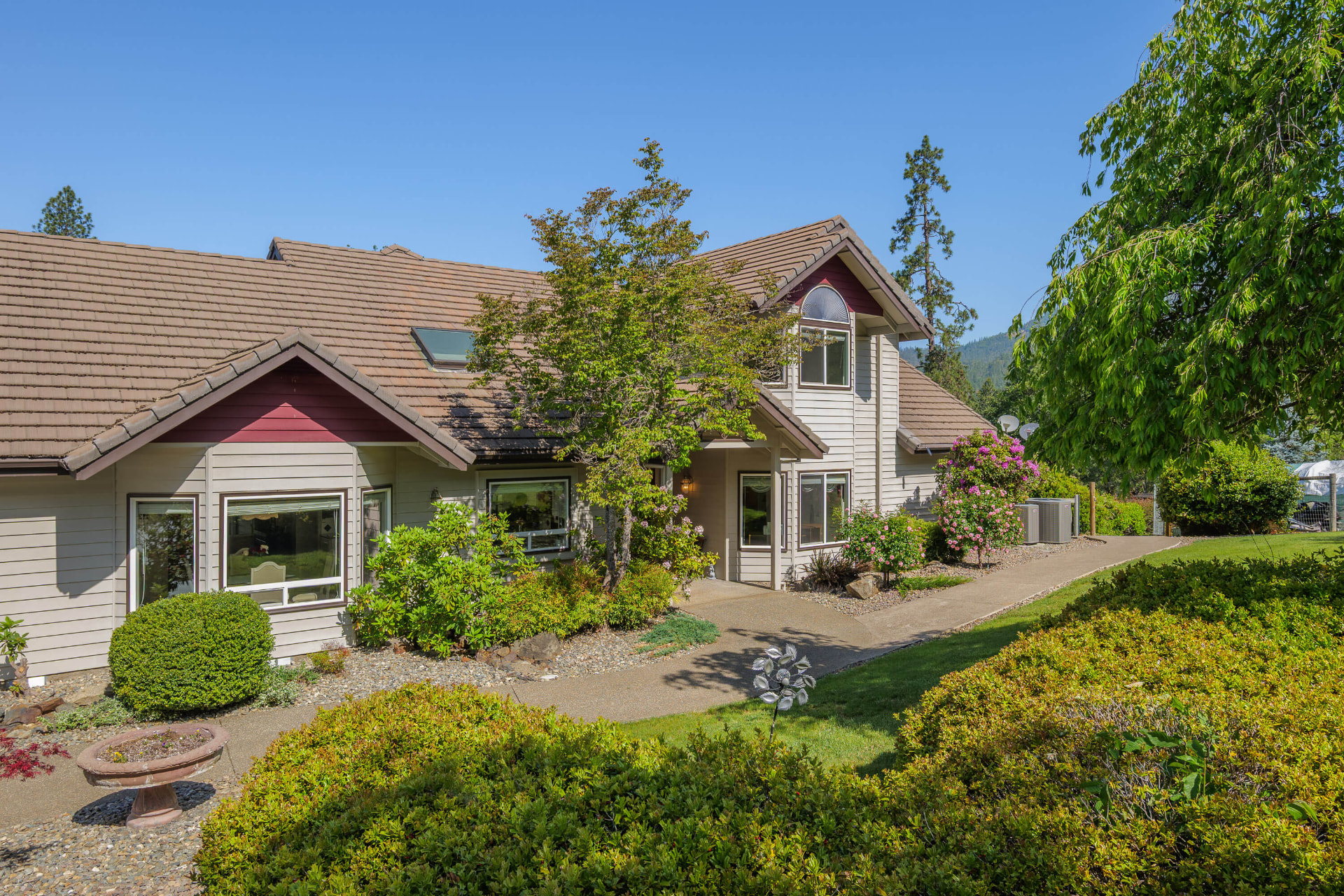Front entry with a paved walkway flanked by planted beds